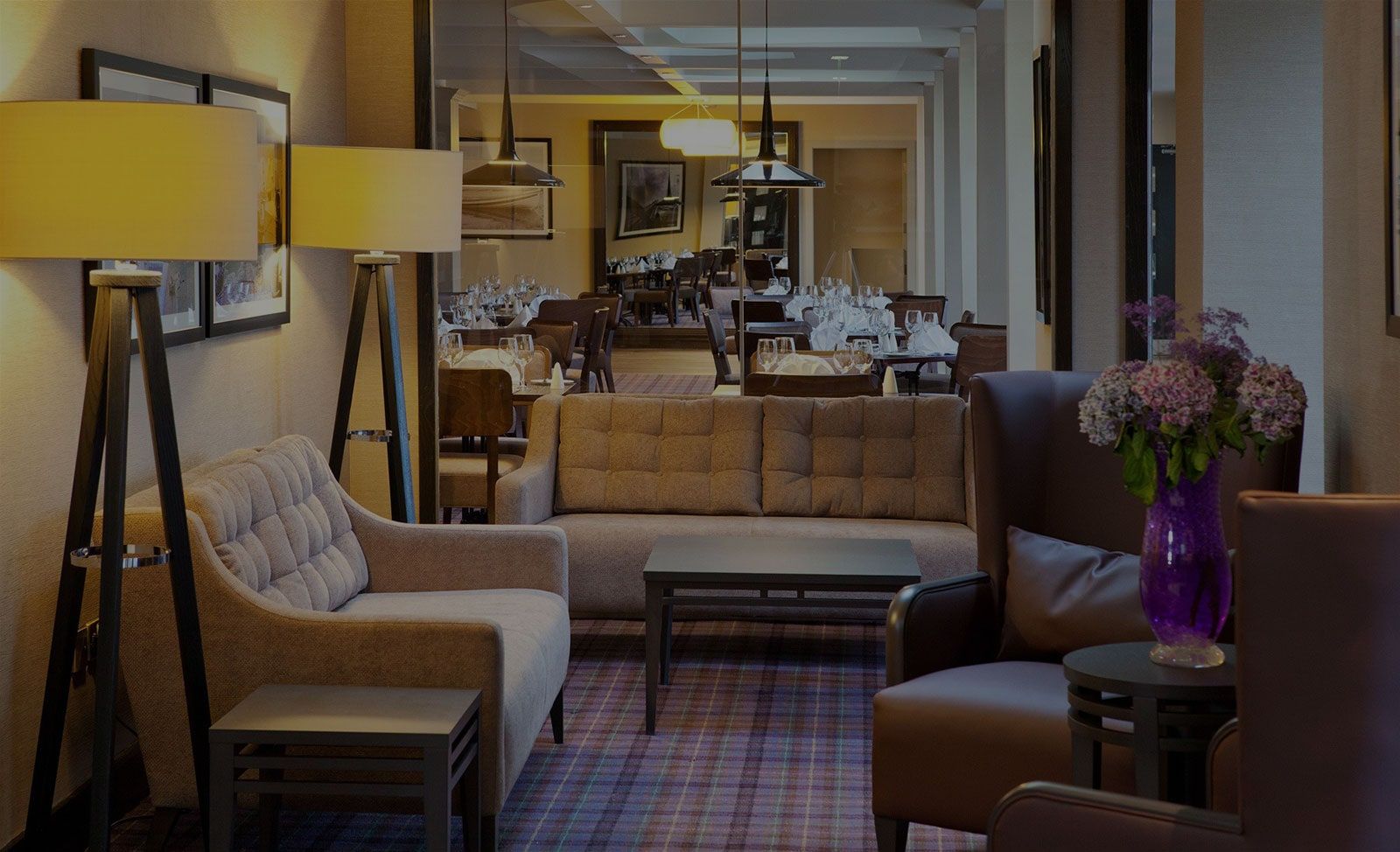 Lounge with armchairs, sofas and soft lighting